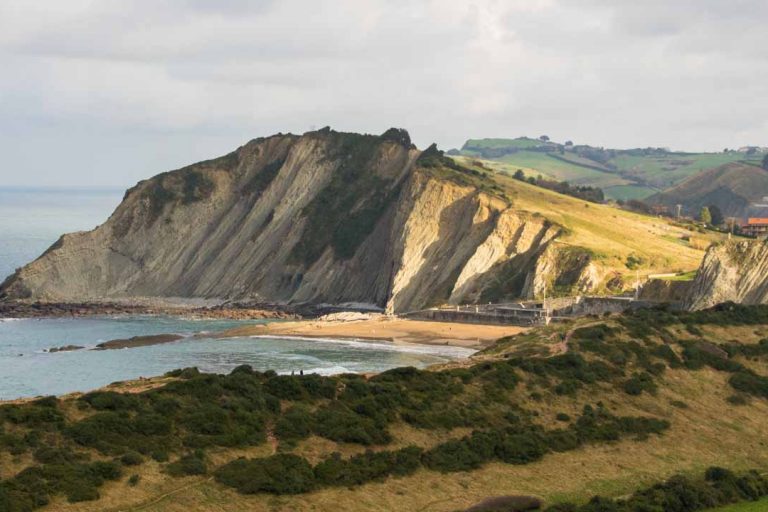 Strand mit darüberliegenden Felsen.
